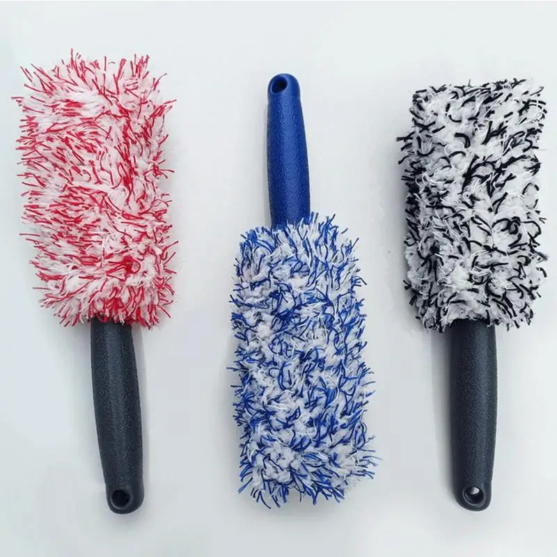Three microfiber wheel cleaning brushes with red, blue, and black bristles on black handles.