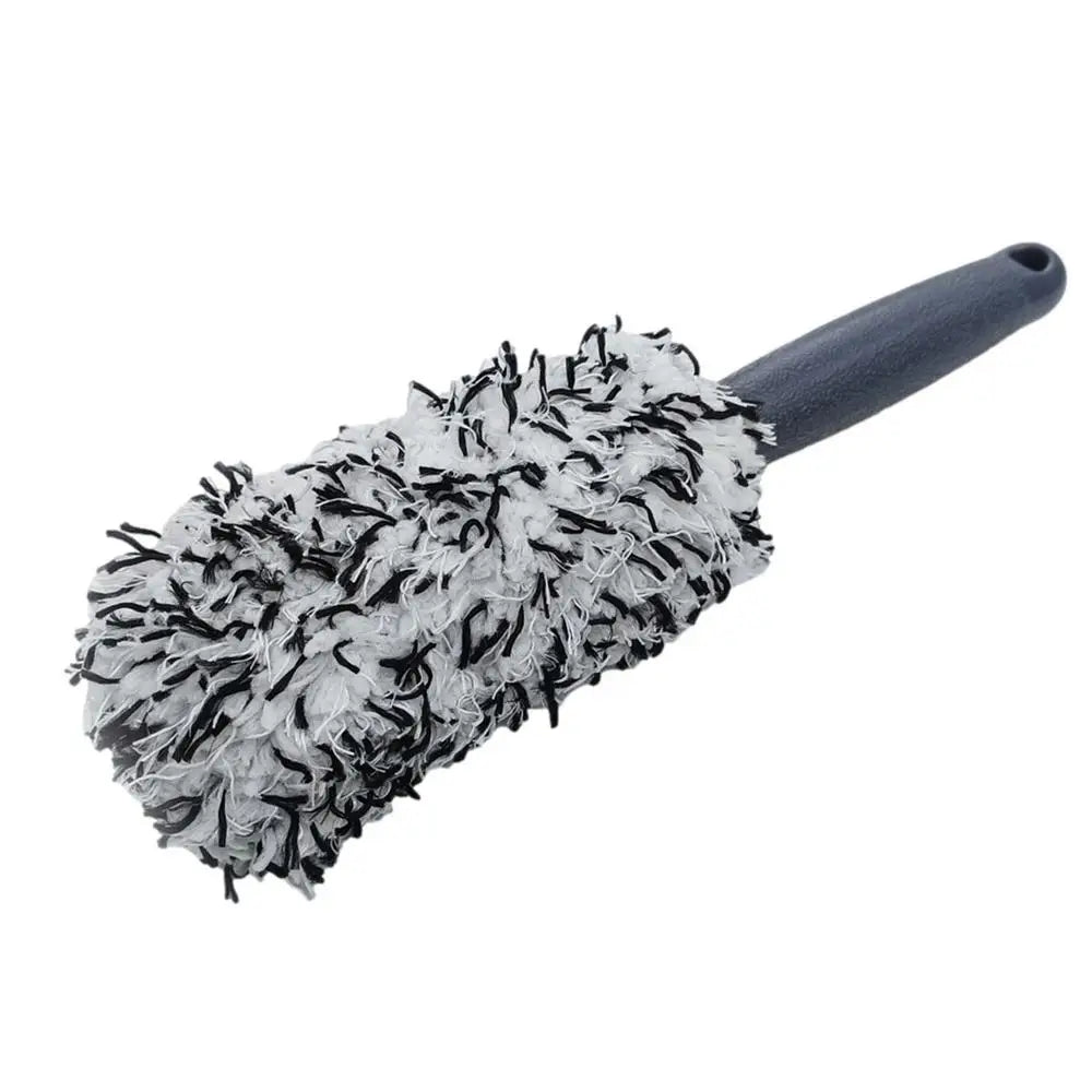 Wheel cleaning brush with black and white microfiber head and grey handle.