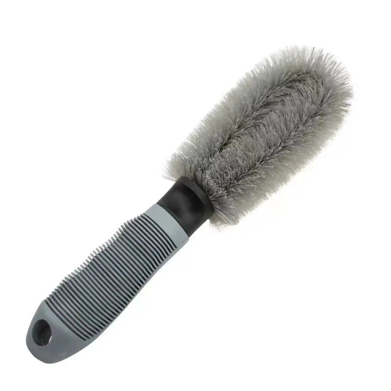 Wheel cleaning brush with gray bristles and a ribbed gray handle.