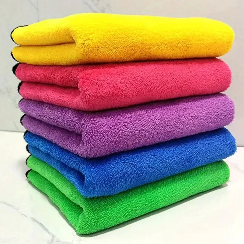 Stack of colorful microfiber cleaning cloths in yellow, red, purple, blue, and green.