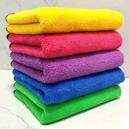 Stack of colorful microfiber cleaning cloths in yellow, red, purple, blue, and green.