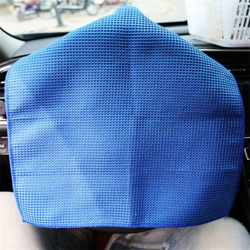 Blue steering wheel cover with textured, waffle-patterned fabric.