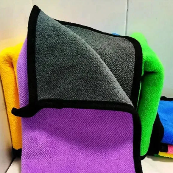 Stack of colorful microfiber cleaning cloths with black trim.