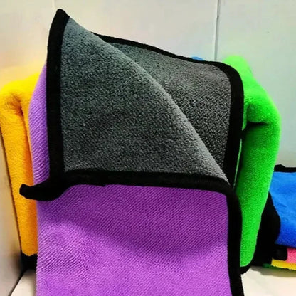 Stack of colorful microfiber cleaning cloths with black trim.