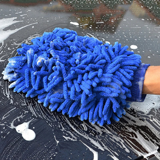 Blue microfiber wash mitt cleaning a car with soap and water.